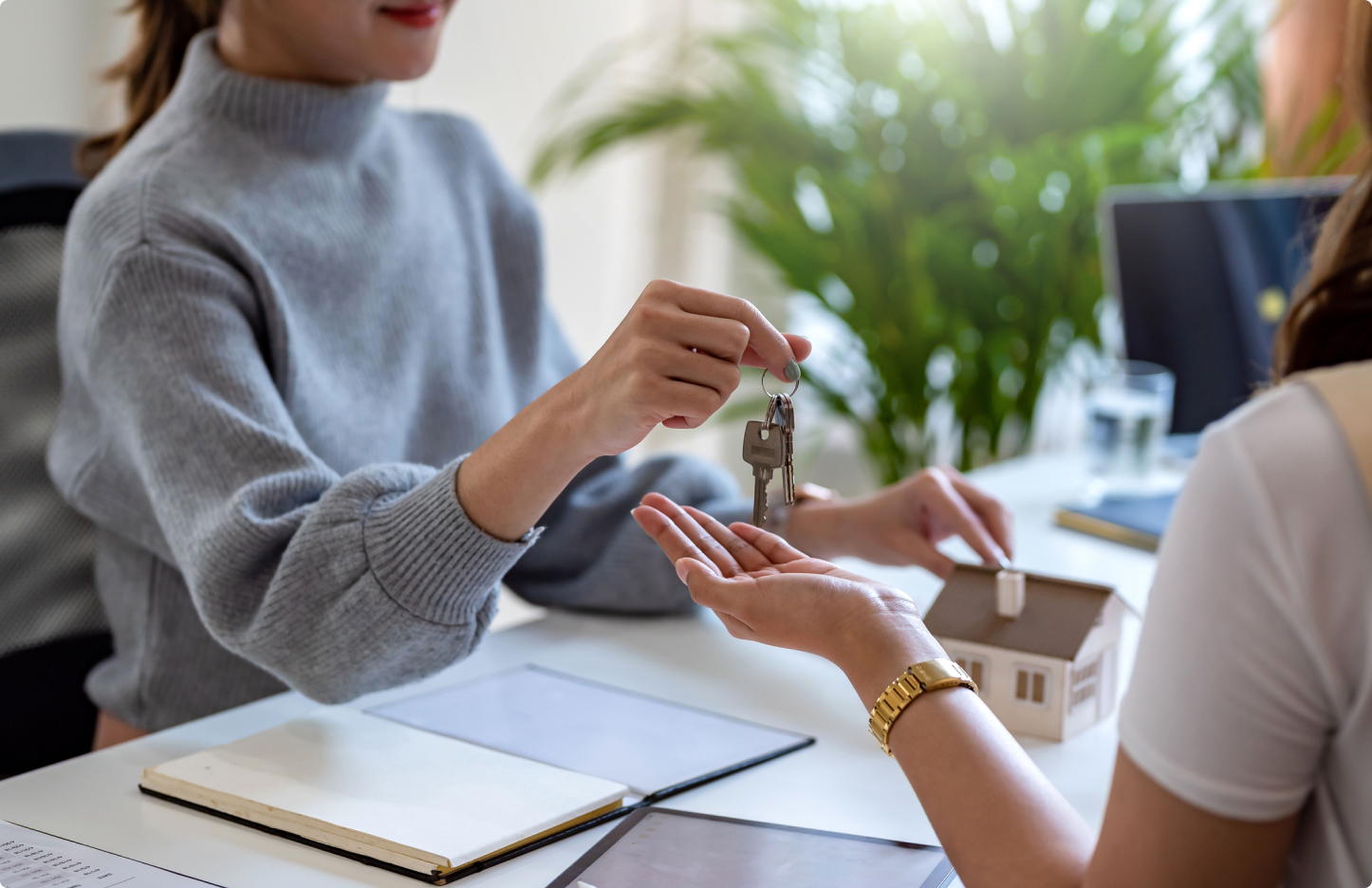 Female executive handing keys to a customer